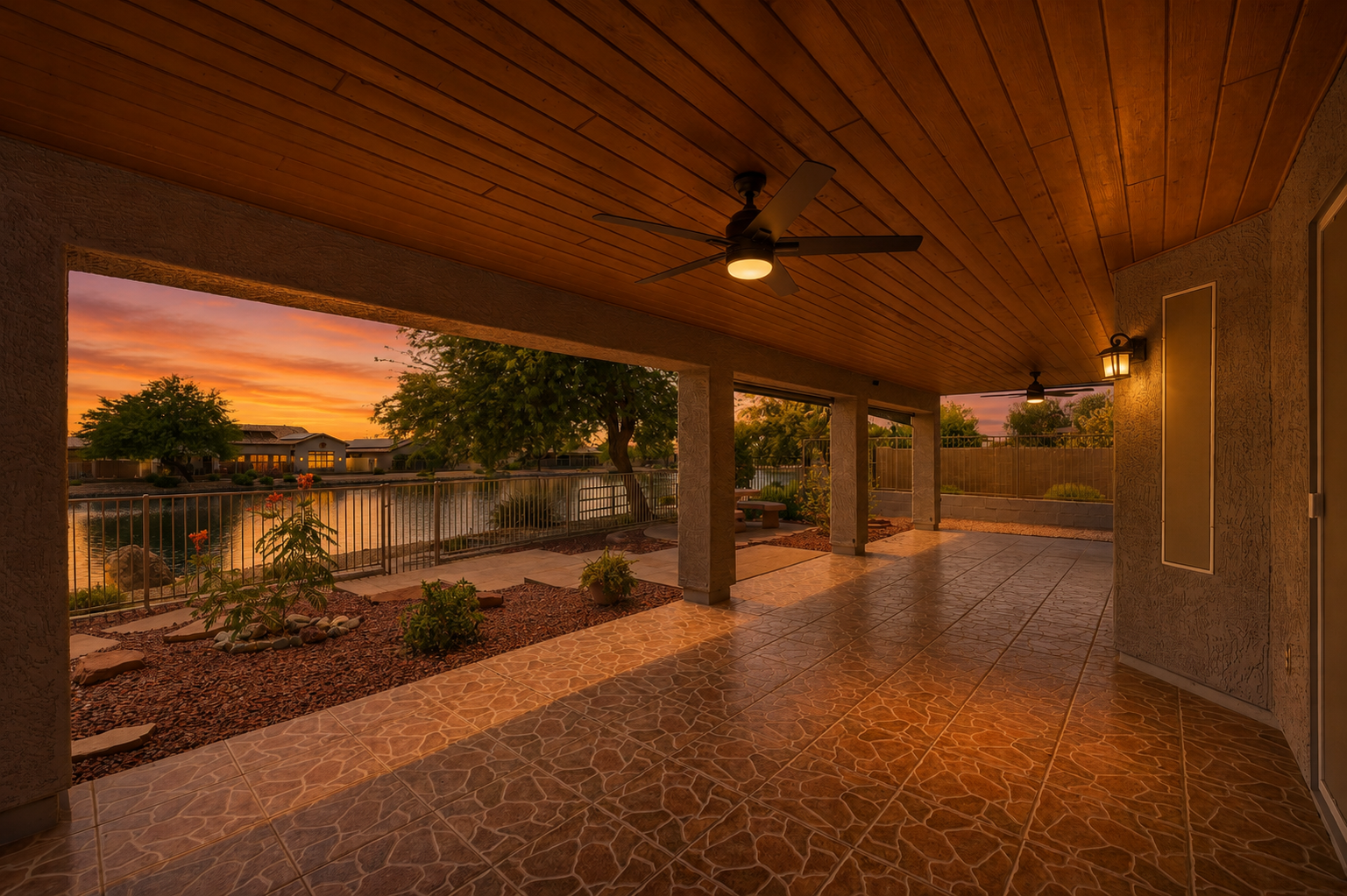 The same lakeside covered patio rendered at golden-hour twilight with warm sky and glowing lights